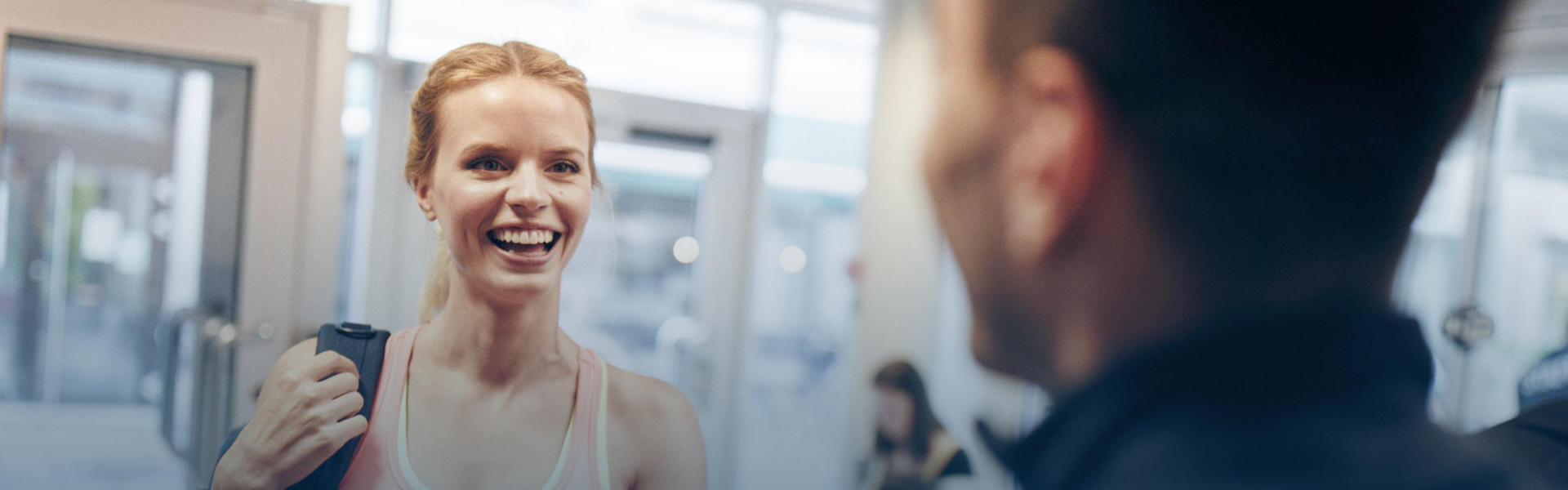 Happy girl entering a gym.
