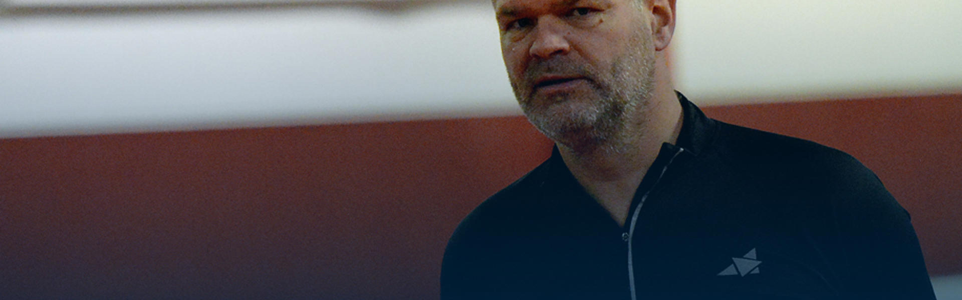Older man looking at the camera in workout clothes.